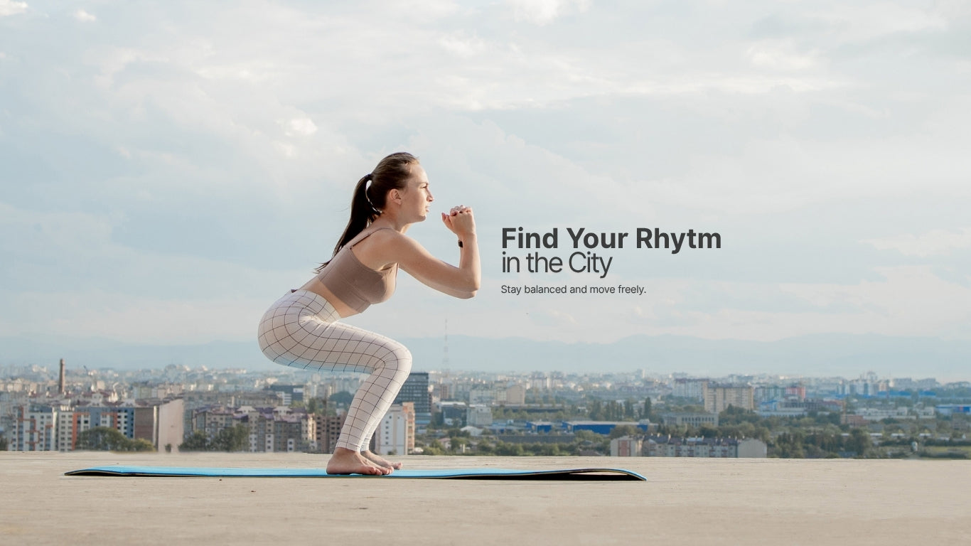 Woman practicing yoga on a rooftop with a cityscape in the background and text 'Find Your Rhythm in the City'.